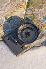Fototapeta na wymiar compass and a map on the snow