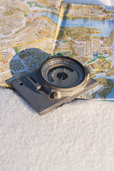 compass and a map on the snow