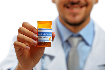 Doctor hand holding bottle with medical cannabis close up