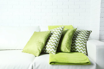 Colorful pillows on sofa, close-up