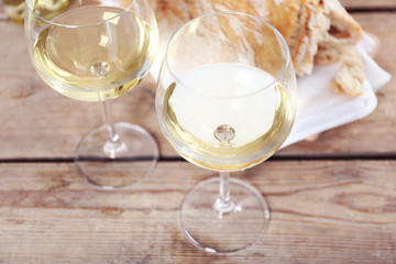 Still life of wine and bread on light background