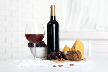 Set of products with wine bottle on light background