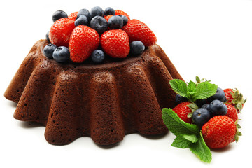 Tasty chocolate muffin with berries isolated on white