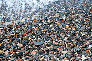 Wet pebbles on sea beach