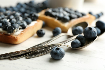 Gourmet fresh blueberry tarts on table