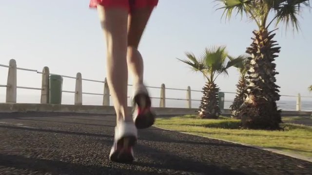 Mixed race woman runner running on road