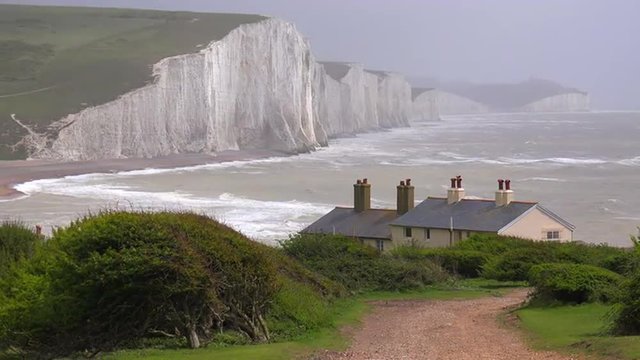Beautiful houses along the shore of the White Cliffs of Dover at Beachy Head, England.