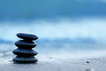 Fototapeta na wymiar Spa stones on sea beach outdoors