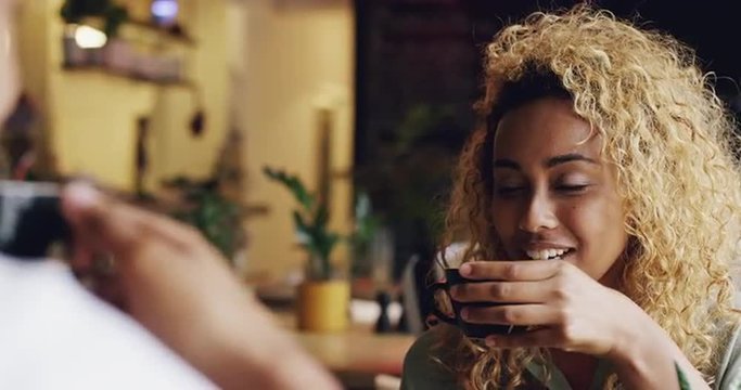Couple on romantic date in cafe laughing pretty woman