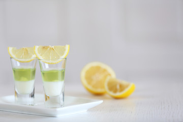 Shot glass with jelly on light background