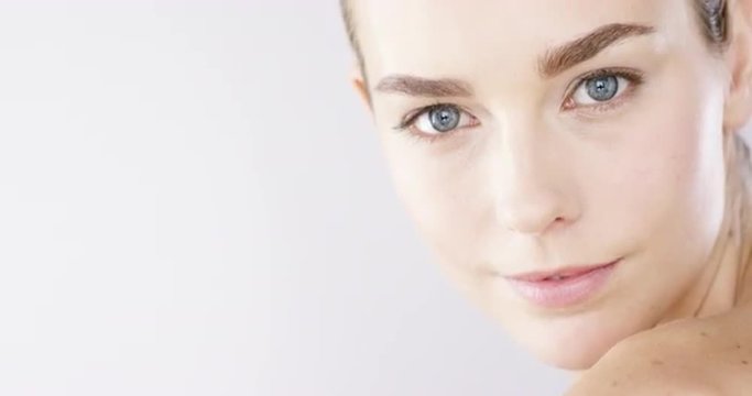 Closeup Beauty portrait of woman face with bright blue eyes slow motion skincare concept - Red Epic Dragon