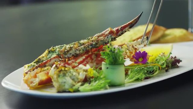 Chef is Garnish Dish with Lobster in Luxury Restaurant