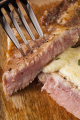 steak, a prepared piece of steak cut with blue cheese sauce on dining table decorated