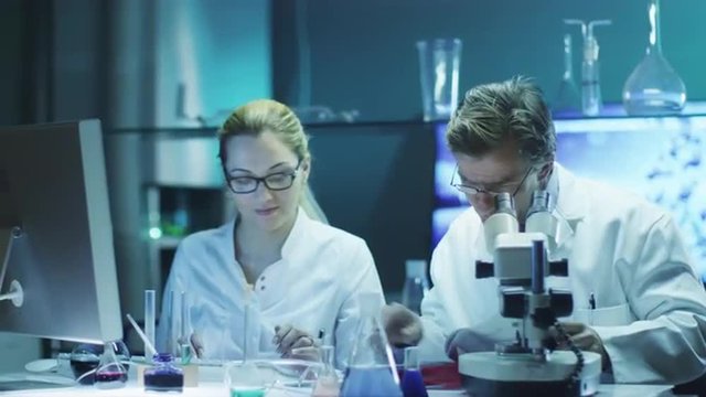 Professor and Student Girl are Doing Chemical Researches in Laboratory.
Shot on RED Cinema Camera in 4K (UHD).