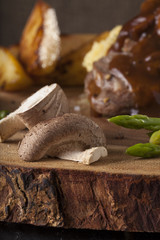 steak sides, champignon mushroom and asparagus served with steak in a meal wooden block plate
