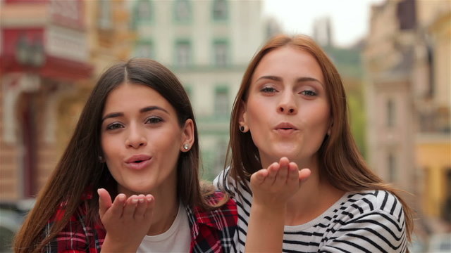 Air-kissing long-haired teen girls