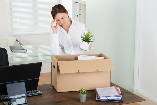 Businesswoman Putting Her Belongings In Box