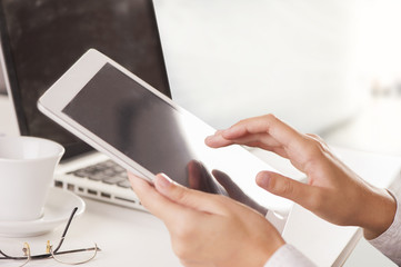 Female hands typing on a laptop keyboard
