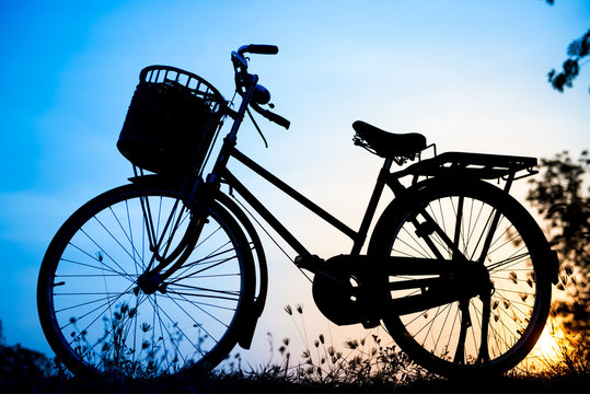 beautiful landscape image with Bicycle silhouette  at blue tone