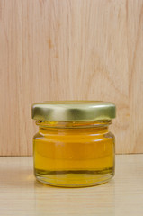 Jars of honey on wooden table