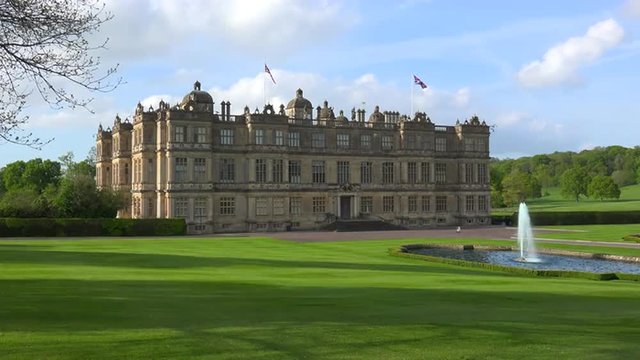 The Longleat mansion in England amidst green lawns and fountains.