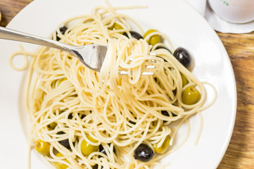 Italian dish of spaghetti with olives and oil