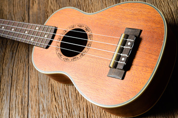 Fototapeta na wymiar Ukulele guitar on wood background