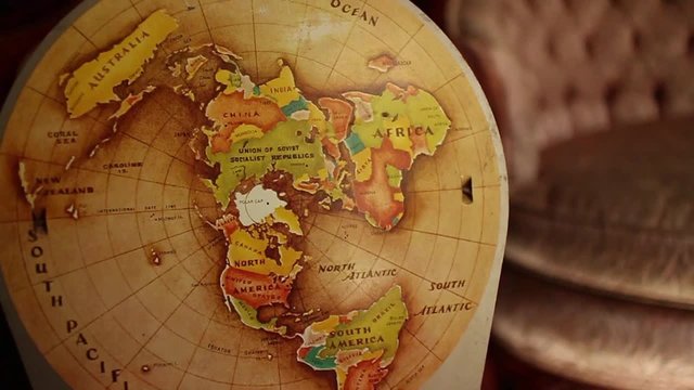 CURRENT SHOT: 60 fps native slow motion circular dolly move back from vintage retro globe-map