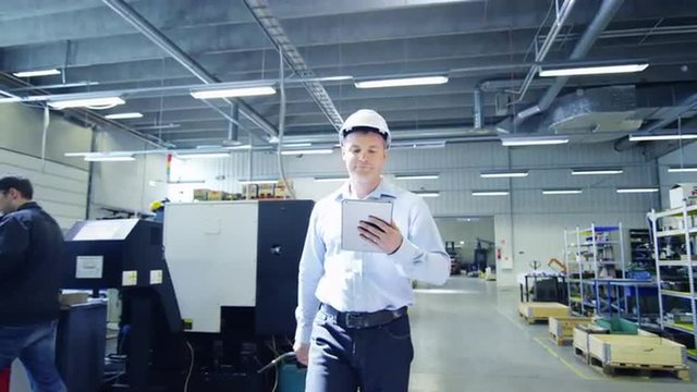 Engineer in Hard Hat is Walking Through Factory and Have Handshake with Worker.