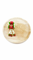 Small Polymer Clay Garland Of Flowers on wooden plate in white background