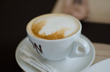 Сup of cappuccino with sugar.