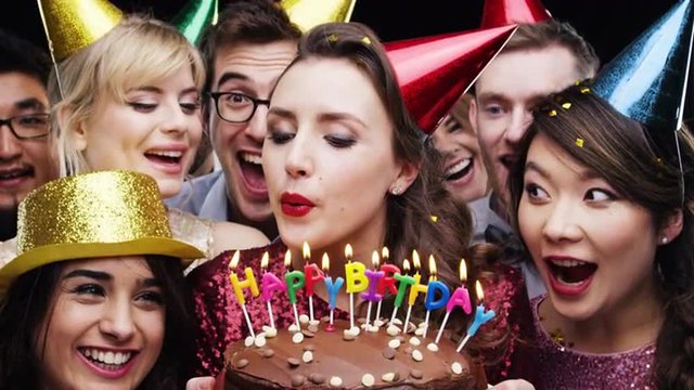 Woman blowing out candles birthday party slow motion photo booth 