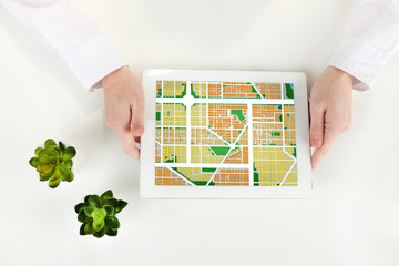 Woman using tablet with map gps navigation application, top view