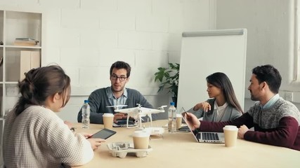 Group of young hipsters discussing drone technology - Powered by Adobe