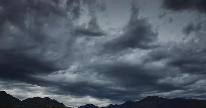 Darkness dramatic sky over the mountains, floating clouds, time lapse 4k video