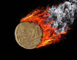 Burning coin with a trail of fire and smoke