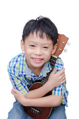 Little Asian boy with ukulele over white background