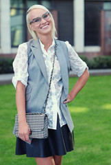 Beautiful stylish young woman on a street