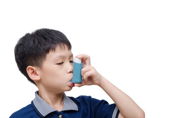 Asian boy using inhaler for asthma over white background