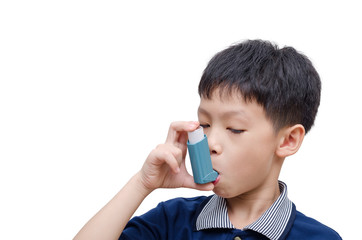 Asian boy using inhaler for asthma over white background