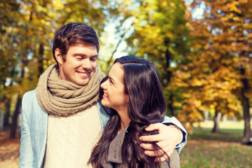 Fototapeta premium smiling couple hugging in autumn park