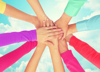 close up of women hands on top in rainbow clothes