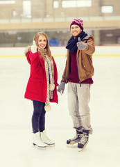 happy couple holding hands on skating rink