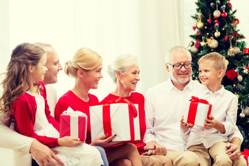 smiling family with gifts at home