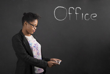 African woman with tablet in the office on blackboard background