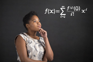 African American woman with hand on chin thinking about maths on blackboard background