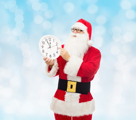 man in costume of santa claus with clock
