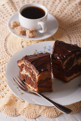 piece of marble cake with chocolate and coffee on the table. vertical
