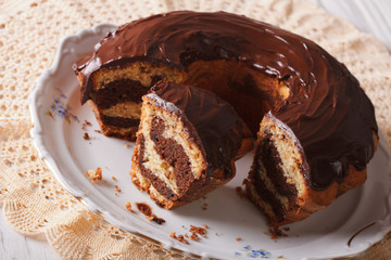 delicious marble cake with chocolate frosting sliced close-up. horizontal

