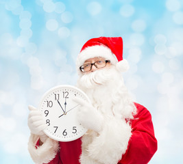 man in costume of santa claus with clock